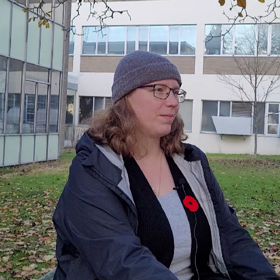 Madelaine Gierc, Postdoctoral Research Fellow. A person sitting down facing towards the right.