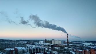 City skyline with steam emitting from building